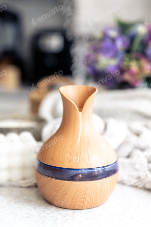 Preview: Spa composition with aroma oil diffuser lamp and candle on a blurred background.
