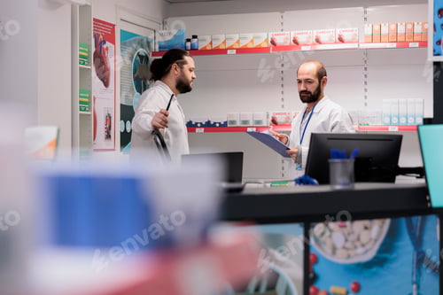 Preview: Drugstore workers in white coat maintains an inventory of all the different types of medication and