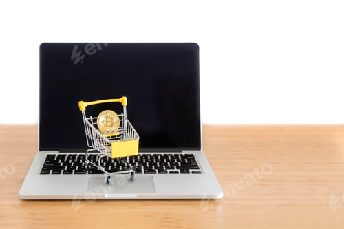 Preview: Cryptocurrency bitcoin in mini supermarket trolley on laptop