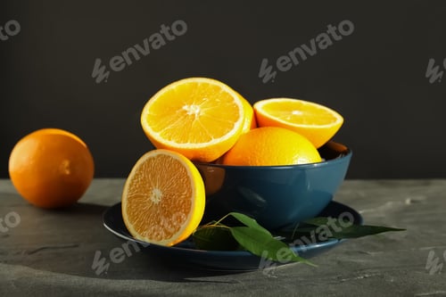 Preview: Fresh oranges in bowl on table. Healthy fruits