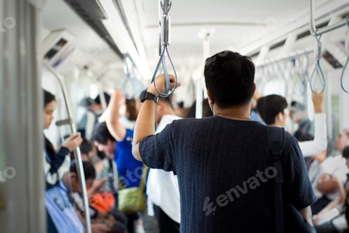 Preview: Back portrait man traveling in the public train with crowd of people in background