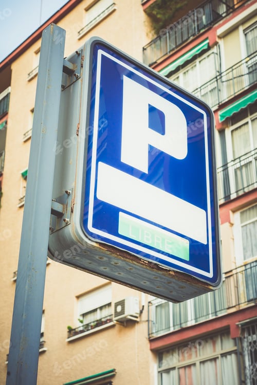 Preview: Vertical low angle shot of a blue parking sign on a pole