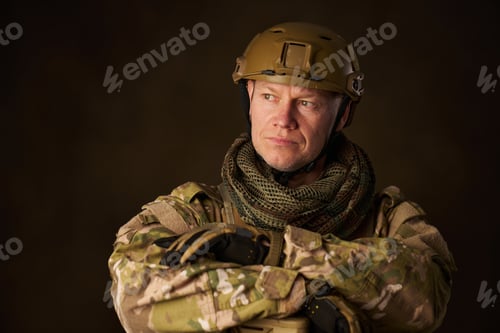 Preview: portrait of a soldier in airsoft camouflage clothing leaning on his rifle