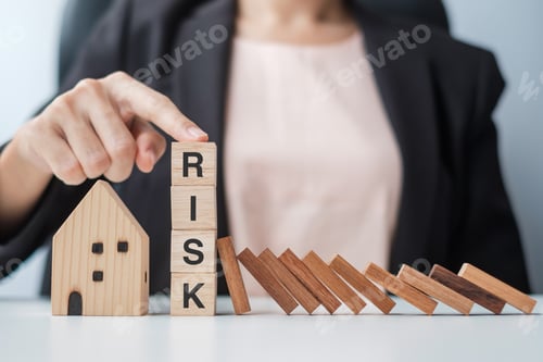 Preview: Businessman stop falling wooden blocks and protect house model. Crisis, fall Business