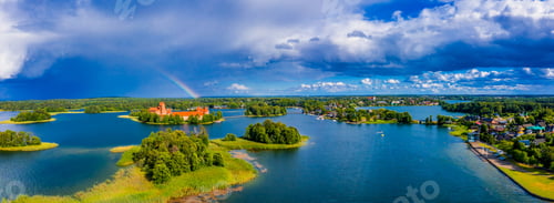 Preview: Aerial shot of an amazing lake surrounded by green forests and an island with an old castle
