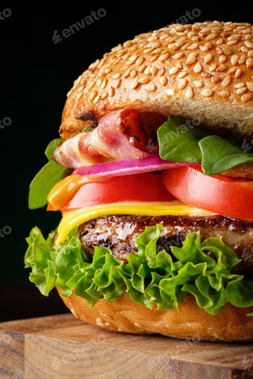 Preview: Fresh homemade tasty burger closeup on dark background. Fast food concept.
