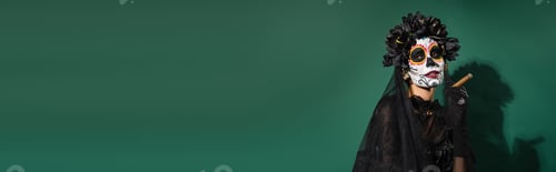 Preview: Woman in mexican day of death costume holding cigar on green background, banner