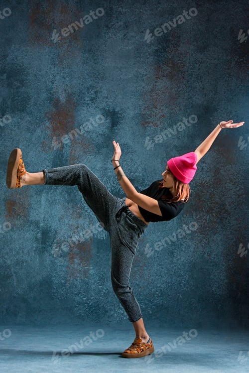 Preview: Young girl break dancing on wall background.