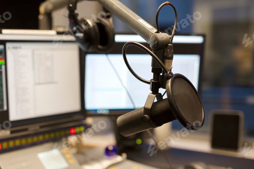 Preview: Studio microphone in front of radio station broadcasting equipment