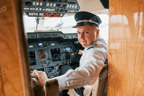 Preview: Looks behind. Pilot on the work in the passenger airplane. Preparing for takeoff