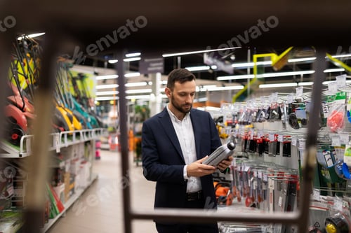 Preview: a man in a business suit chooses engine oil for a lawn mower