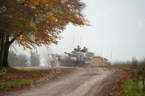 Preview: Military tank and soldiers with guns on a field