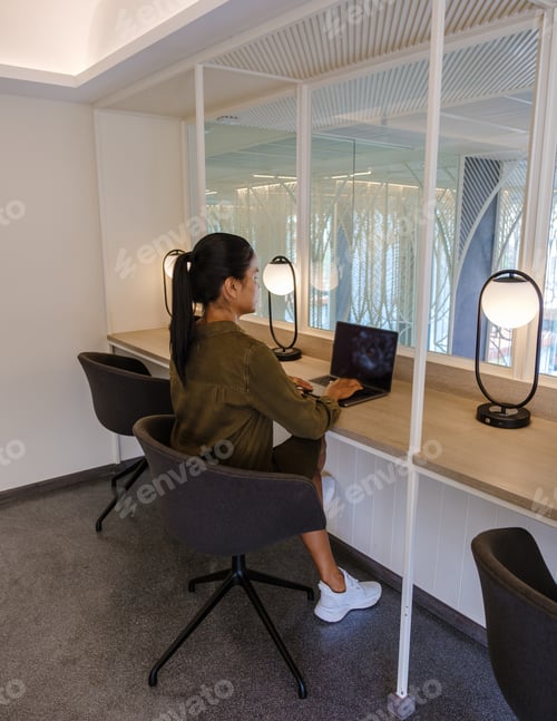 Preview: Asian women working in a hotel working space in a hotel for workation, commong working room in hotel