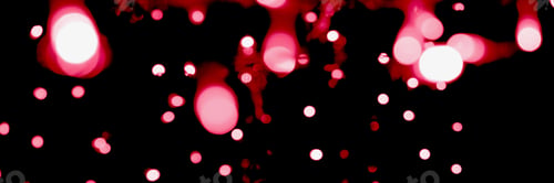 Preview: Blurry garland lights on a dark background. Image toned in color of the year 2023 viva magenta