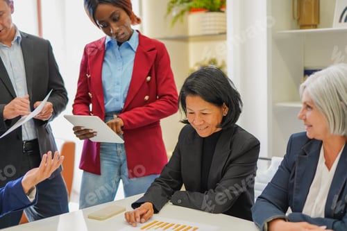 Preview: Multi generational business people working inside modern office