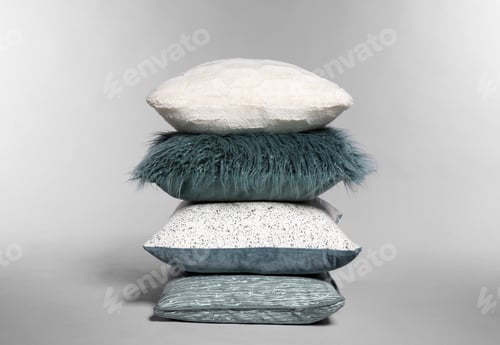 Preview: Stylish decorative pillows stacked on light background