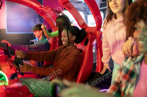 Preview: Group of young friends playing an exciting racing game