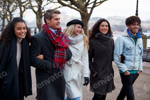 Preview: Friends Walking Along South Bank On Winter Visit To London