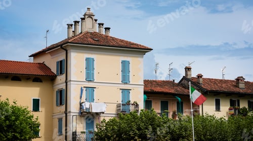 Preview: Charming buildings and vibrant colors in Isola Bella Italy with a sunny sky backdrop