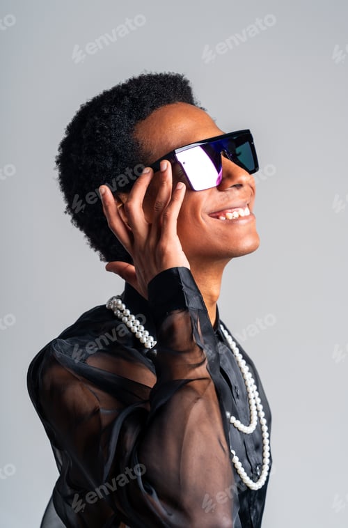 Preview: Fashionable fluid gender man posing in studio