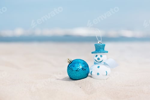 Preview: New Year's snowman in white in a blue hat on a background of a beautiful sea