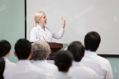 Preview: Female doctor giving speech in boardroom