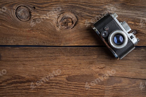 Preview: Vintage camera on wooden background.