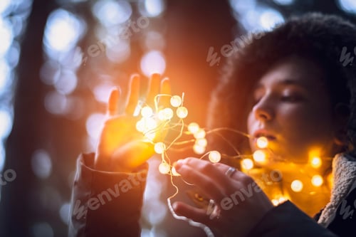 Preview: ↟ A girl holding bright shining garlands in her hands.