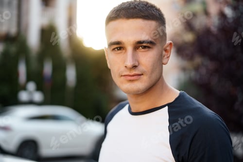 Preview: Portrait of handsome young casual man walking on the street