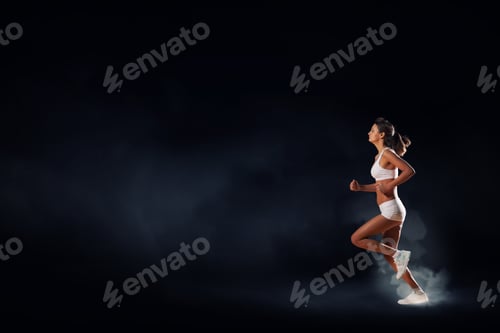 Preview: Woman Running Against Dark Background in Studio Shot