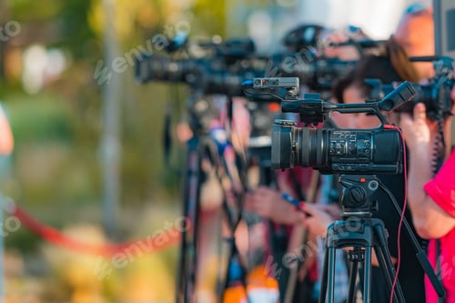 Preview: Group of Cameras at an Outdoor Press Conference