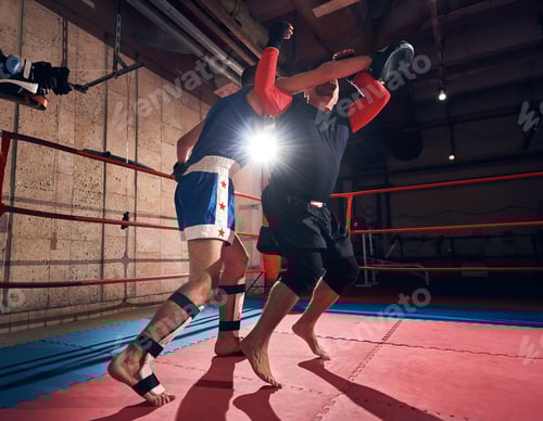 Preview: Boxers training kickboxing in the ring at the health club
