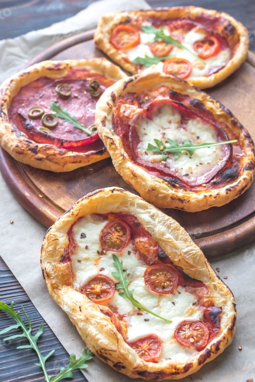 Mini Pizzas with Tomatoes and Pepperoni on Wood