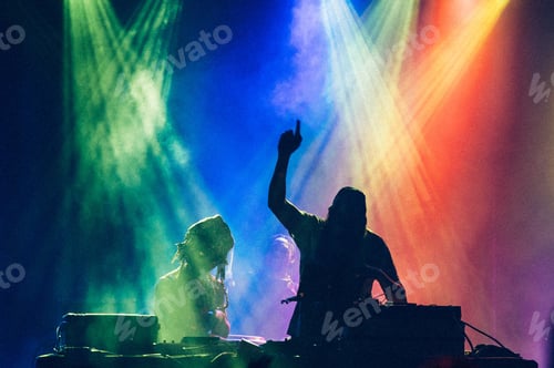 Preview: silhouette of dj playing with colored lights.