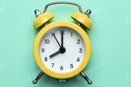 Preview: Yellow round alarm clock on the cyan background.