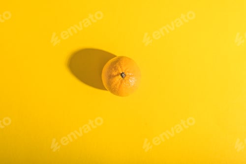 Preview: Juicy orange on a yellow background.