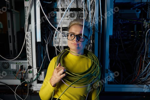 Preview: Portrait of tired overwhelmed female IT engineer at server room