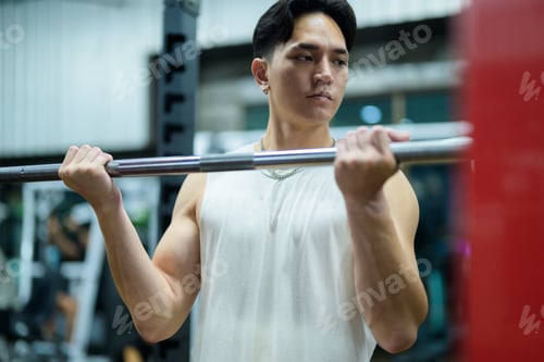 Preview: Athlete lifting weights during intense workout session in gym