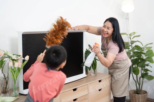Preview: Family Cleaning and Home Care. A woman and her child cleaning a TV stand together with joy.