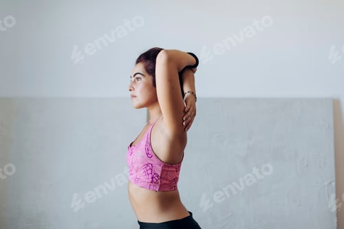 Preview: Woman stretching her arm before a workout