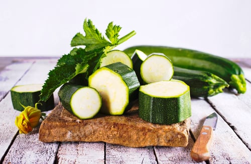Preview: Slicing zucchini on a cutting board. Ripe zucchini. Top view, horizontal.
