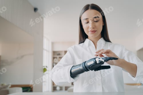Preview: Happy handicapped girl is setting the prosthesis functions at home. Modern orthopedic technology.