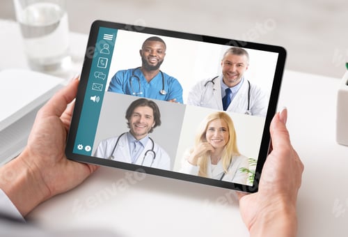 Preview: Woman With Tablet Having Consultation With Doctors Via Video Call