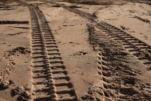 Preview: Tire tracks on sandy terrain show off-road adventure, rugged travel, outdoor exploration in nature.