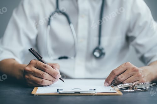 Preview: Doctor working writing clipboard on desk.