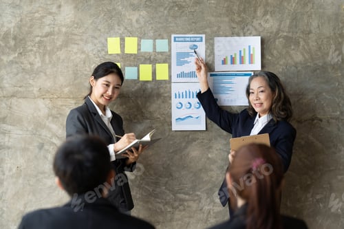 Preview: Confident female manager presenting financial report speak at team meeting talk to employees group