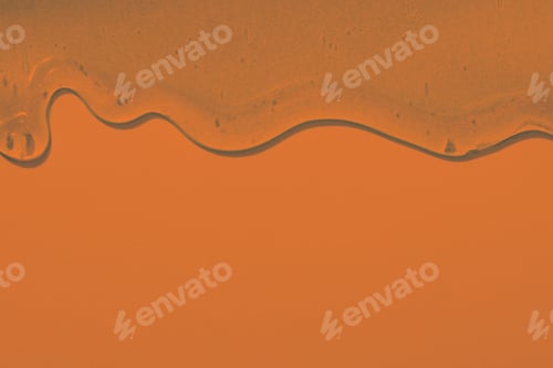 Preview: viscous pure transparent cosmetic gel on orange background. tactile , skincare, cosmetics concept