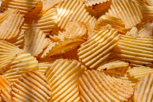 Preview: background corrugated golden chips with texture. selective focus, daylight