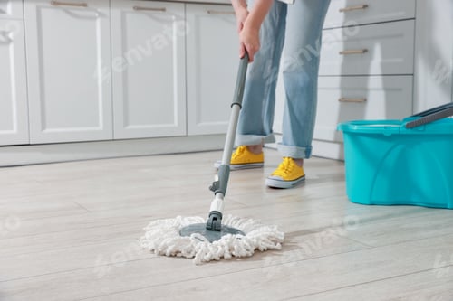 Preview: Woman cleaning floor with mop at home, closeup. Space for text