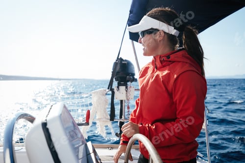 Preview: Attractive strong woman sailing with her boat